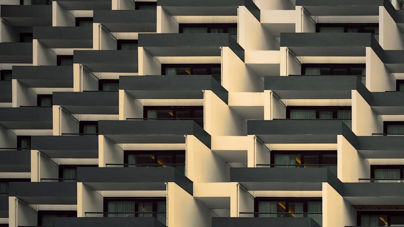Geometric pattern of stepped balconies on a building facade