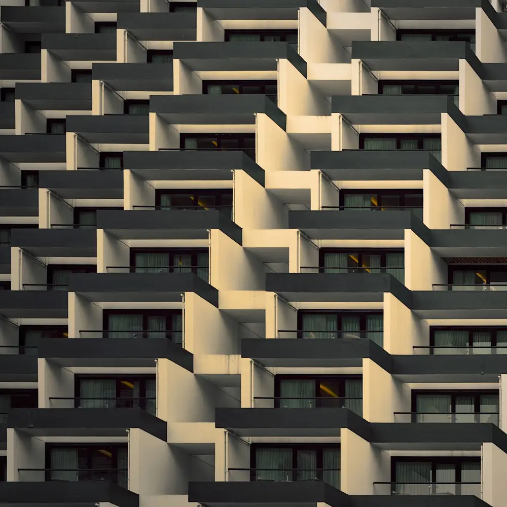 Geometric pattern of stepped balconies on a building facade
