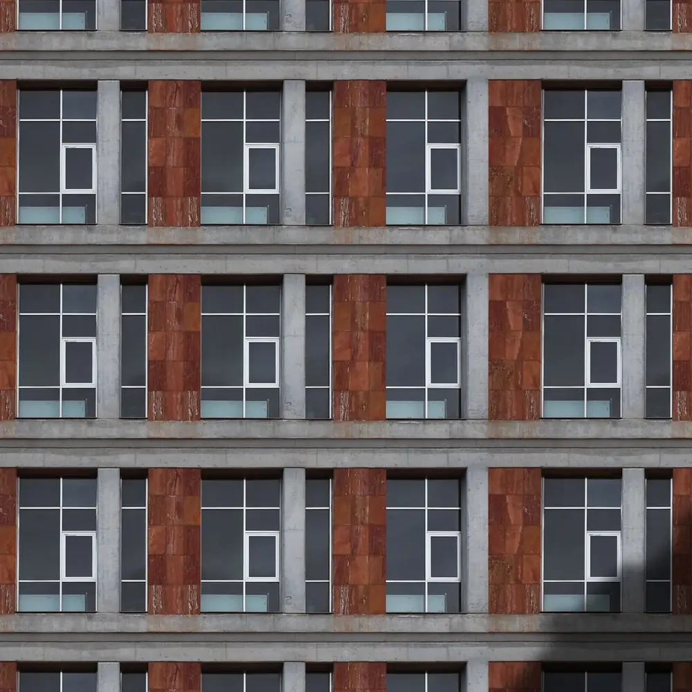 Building facade with a regular grid of windows and concrete columns