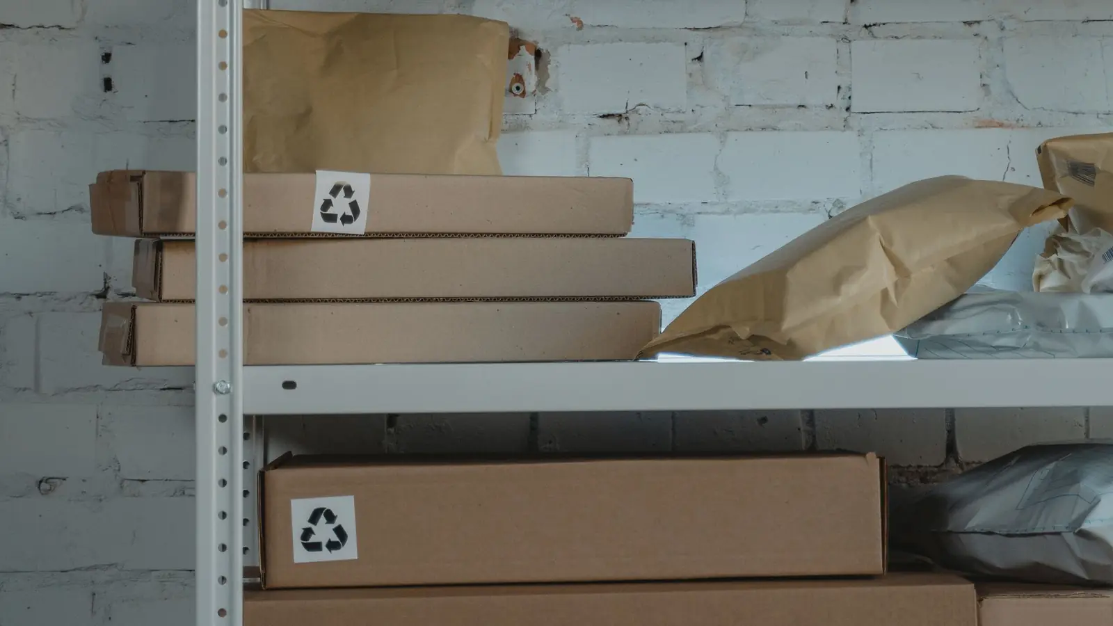 Brown corrugated boxes stacked on a metal shelf