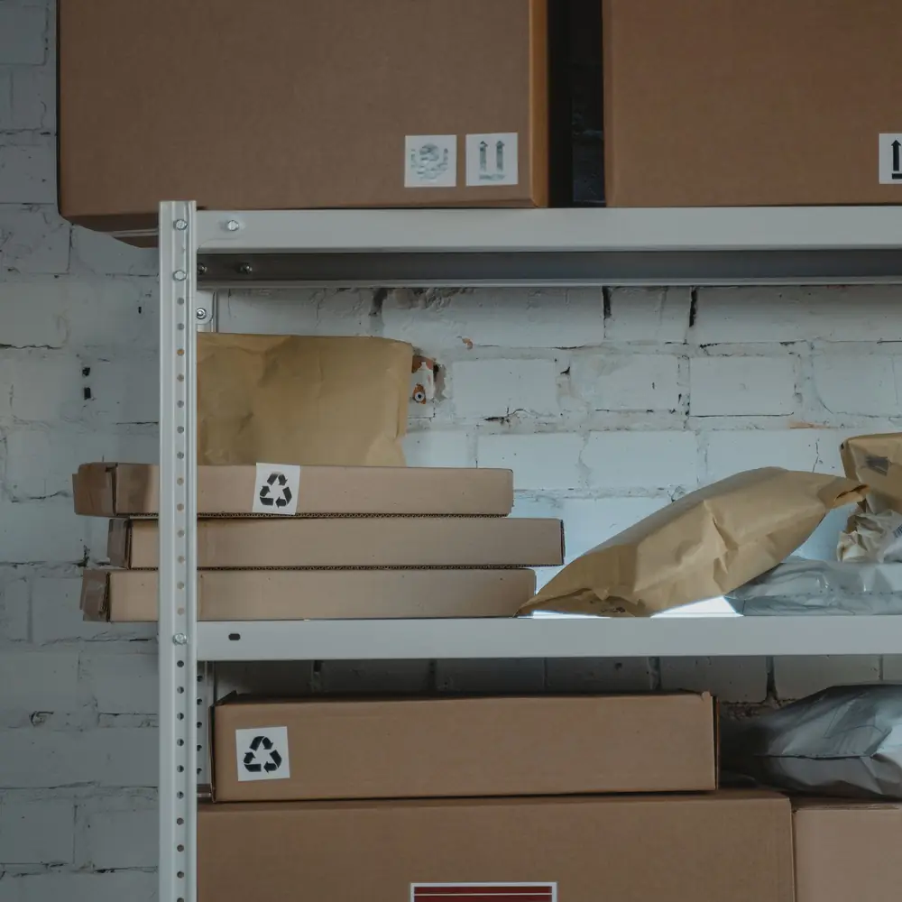 Brown cardboard boxes stacked on a metal shelf